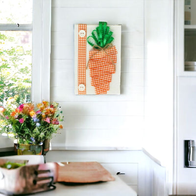 Orange and white checkered grosgrain ribbon make up the carrot and shiny, satin ribbon is used for the stems or fronds.